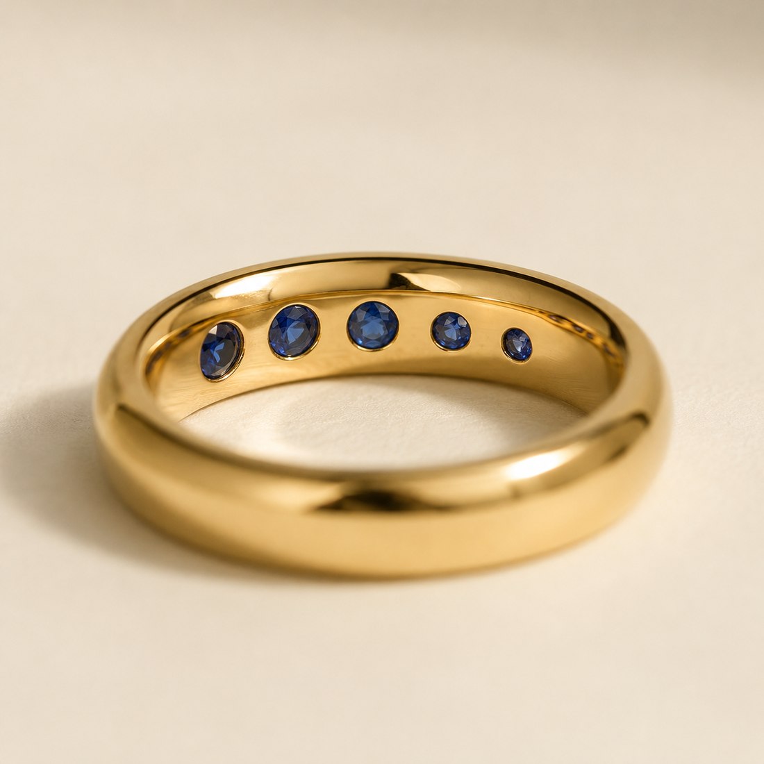 Small sapphires set flush into the inner surface of a ring band