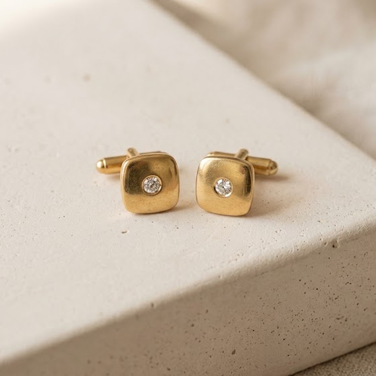 A pair of diamond-set gold cufflinks